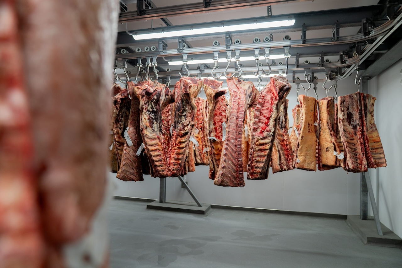 Beef carcasses stored on an overhead twin track meat rail system